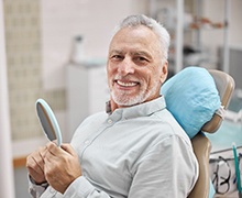 Smiling patient visiting their dental implant dentist in Port Orange