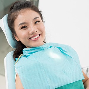 Female dental patient smiling in chair