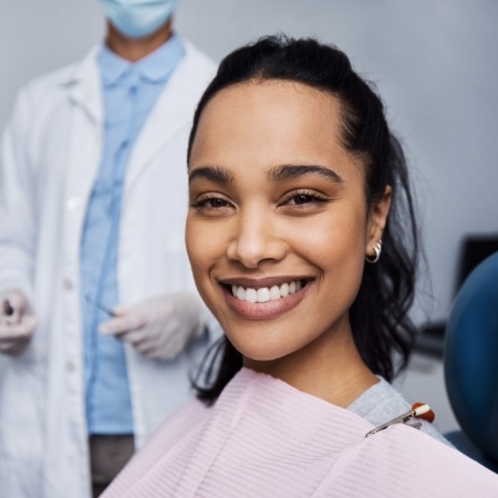 Woman sitting in dental chair and smiling