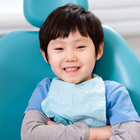 Little boy sitting in dental chair and smiling