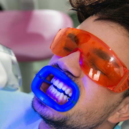 Man receiving a teeth whitening treatment