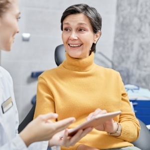 Woman in yellow shirt sitting in dental chair