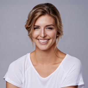 Blonde woman in a white shirt smiling