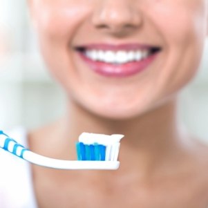 Smiling woman holding a toothbrush