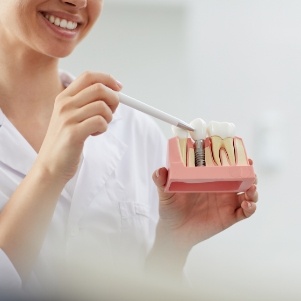 Pointing to a model of a dental implant