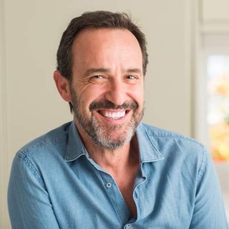 Bearded man with blue shirt smiling