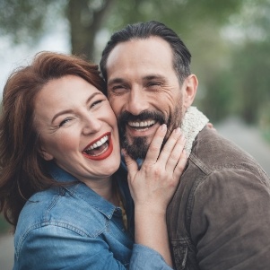 Woman and man hugging and smiling