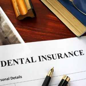 Dental insurance form on a crowded desk