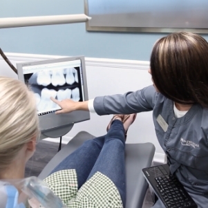 Showing patient image of teeth on monitor