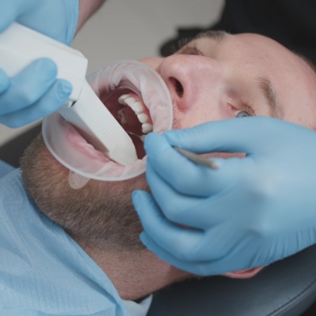 Male dental patient having digital impression taken
