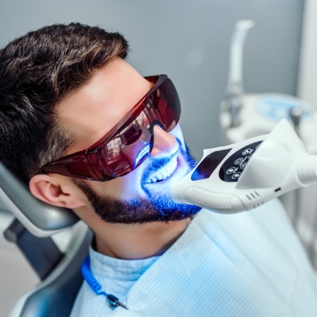 Man in dental chair receiving teeth whitening in Port Orange