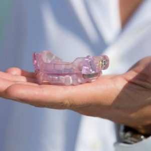 Holding an occlusal splint for TMJ disorder